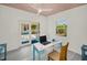 Bright studio interior with plank floors, featuring views to the home's backyard and patio at 420 Roanoke St, Dunedin, FL 34698