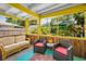 Sunroom with casual seating, screened windows, and view to backyard at 420 Roanoke St, Dunedin, FL 34698
