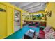 Relaxing sunroom featuring comfortable seating, tropical views, and bright colors at 420 Roanoke St, Dunedin, FL 34698