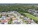 Wide aerial view of the neighborhood and adjacent nature preserve and lakes at 4812 El Capistrano Dr, Tampa, FL 33634