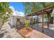 Spacious backyard featuring a covered patio, minimalist landscaping, and mature trees at 4812 El Capistrano Dr, Tampa, FL 33634