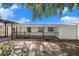 Wide backyard view featuring a covered patio, brick pavers, and a fenced boundary at 4812 El Capistrano Dr, Tampa, FL 33634