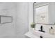 Stylish bathroom showcasing modern black fixtures, sleek tiling, and decorative touches at 4812 El Capistrano Dr, Tampa, FL 33634