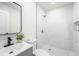 Modern bathroom features marble tiling in the shower with niche and new fixtures at 4812 El Capistrano Dr, Tampa, FL 33634