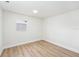 Bedroom featuring new wood floors, a window, and a single recessed light at 4812 El Capistrano Dr, Tampa, FL 33634