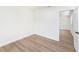 Clean bedroom with new floors, fresh white paint, and a doorway to another room at 4812 El Capistrano Dr, Tampa, FL 33634