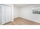 Bright bedroom features new floors, fresh white paint, and a closet for optimal storage at 4812 El Capistrano Dr, Tampa, FL 33634
