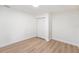 Cozy bedroom featuring wood-look floors, a double closet, and neutral paint at 4812 El Capistrano Dr, Tampa, FL 33634
