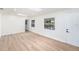 Sunlit room with modern light-colored floors, white walls, a skylight and exterior door at 4812 El Capistrano Dr, Tampa, FL 33634