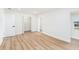Bedroom features wood floors, white walls, open closet and a large window at 4812 El Capistrano Dr, Tampa, FL 33634