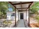 Covered pathway to the home's front door featuring minimalist landscaping at 4812 El Capistrano Dr, Tampa, FL 33634