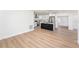 Open concept living room with wood floors and a view of the kitchen at 4812 El Capistrano Dr, Tampa, FL 33634