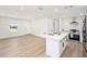 A renovated living room and kitchen with an island and modern appliances at 4812 El Capistrano Dr, Tampa, FL 33634