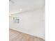Empty room showcases new floors, recessed lighting, fresh white paint, and a window at 4812 El Capistrano Dr, Tampa, FL 33634