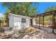 View of the shed featuring a pergola-covered brick pathway and minimalist landscaping at 4812 El Capistrano Dr, Tampa, FL 33634
