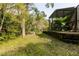 A secluded backyard abuts dense, natural woods at 5619 Essex Ct, Palm Harbor, FL 34685