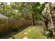 Fenced backyard with lush greenery, offering a secure outdoor space with natural beauty at 5619 Essex Ct, Palm Harbor, FL 34685