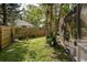 Fenced backyard with lush greenery and stepping stones, creating a charming outdoor space at 5619 Essex Ct, Palm Harbor, FL 34685