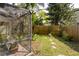 Fenced backyard with tropical plants and greenery, creating a lush and private outdoor space at 5619 Essex Ct, Palm Harbor, FL 34685