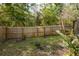 Fenced backyard with lush greenery, providing a private and serene outdoor living space at 5619 Essex Ct, Palm Harbor, FL 34685