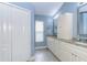 Bright bathroom featuring double vanity, granite countertop, and view of the linen closet at 5619 Essex Ct, Palm Harbor, FL 34685