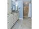Bathroom featuring granite vanity, and a neutral-toned tile shower with glass door at 5619 Essex Ct, Palm Harbor, FL 34685