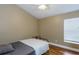 Bedroom featuring light brown walls, a ceiling fan, wood floors, and a small window at 5619 Essex Ct, Palm Harbor, FL 34685