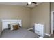 Bedroom with plush carpet, neutral walls, a ceiling fan, and a white bed frame and headboard at 5619 Essex Ct, Palm Harbor, FL 34685