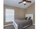 Bedroom featuring plush carpet, a ceiling fan, and a white bed frame and headboard at 5619 Essex Ct, Palm Harbor, FL 34685