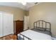 Bedroom featuring dark wood floors, a black metal bed frame, and a dresser at 5619 Essex Ct, Palm Harbor, FL 34685