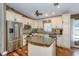 Traditional kitchen featuring stainless steel appliances, center island, and custom backsplash at 5619 Essex Ct, Palm Harbor, FL 34685