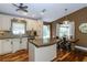 Open kitchen and dining area featuring granite countertops and wood flooring at 5619 Essex Ct, Palm Harbor, FL 34685