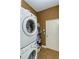 Convenient laundry room features stacked washer and dryer, plus built-in storage at 5619 Essex Ct, Palm Harbor, FL 34685