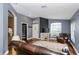 Spacious living room showcasing wood floors, neutral walls, and a partial view of other rooms at 5619 Essex Ct, Palm Harbor, FL 34685