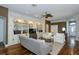Open living room with custom built-ins, ceiling fan, and seamless flow at 5619 Essex Ct, Palm Harbor, FL 34685