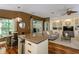 Inviting open-concept featuring a kitchen island, dining, and built-in shelves at 5619 Essex Ct, Palm Harbor, FL 34685