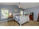 Cozy main bedroom with neutral paint, ceiling fan, and ample natural light at 5619 Essex Ct, Palm Harbor, FL 34685