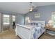 Light and airy main bedroom with access to outdoor space, neutral walls and ceiling fan at 5619 Essex Ct, Palm Harbor, FL 34685