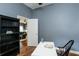 Cozy office space with white desk, bright natural light, and laminate wood flooring at 5619 Essex Ct, Palm Harbor, FL 34685
