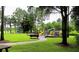 Community playground with lush green surroundings, providing a safe and enjoyable space for children at 5619 Essex Ct, Palm Harbor, FL 34685