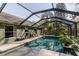 Enjoy the private, screened-in pool and attached spa with outdoor seating at 5619 Essex Ct, Palm Harbor, FL 34685