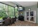 Outdoor dining on screened patio with grill, ceiling fan, and access to the house at 5619 Essex Ct, Palm Harbor, FL 34685