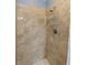 Close-up of the shower with neutral tile surround and a shower head with caddy at 5619 Essex Ct, Palm Harbor, FL 34685