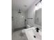 Remodeled bathroom with marble-style tiling, walk-in shower, and modern vanity with black hardware at 5817 Liverpool Dr, Tampa, FL 33615