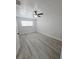 Neutral bedroom featuring light gray wood flooring and a ceiling fan at 5817 Liverpool Dr, Tampa, FL 33615