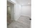 Bright bonus room with light gray wood flooring at 5817 Liverpool Dr, Tampa, FL 33615