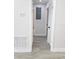 Hallway view featuring gray vinyl flooring and access to other rooms and a bathroom at 5817 Liverpool Dr, Tampa, FL 33615