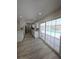 Open layout connects living area to kitchen, enhanced by view of screened pool from sliding glass doors at 5817 Liverpool Dr, Tampa, FL 33615