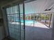 Screened-in pool with lake view, accessible through sliding glass door at 5817 Liverpool Dr, Tampa, FL 33615
