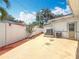 Backyard with concrete patio, white fence and some landscaping at 6350 18Th N Ave, St Petersburg, FL 33710